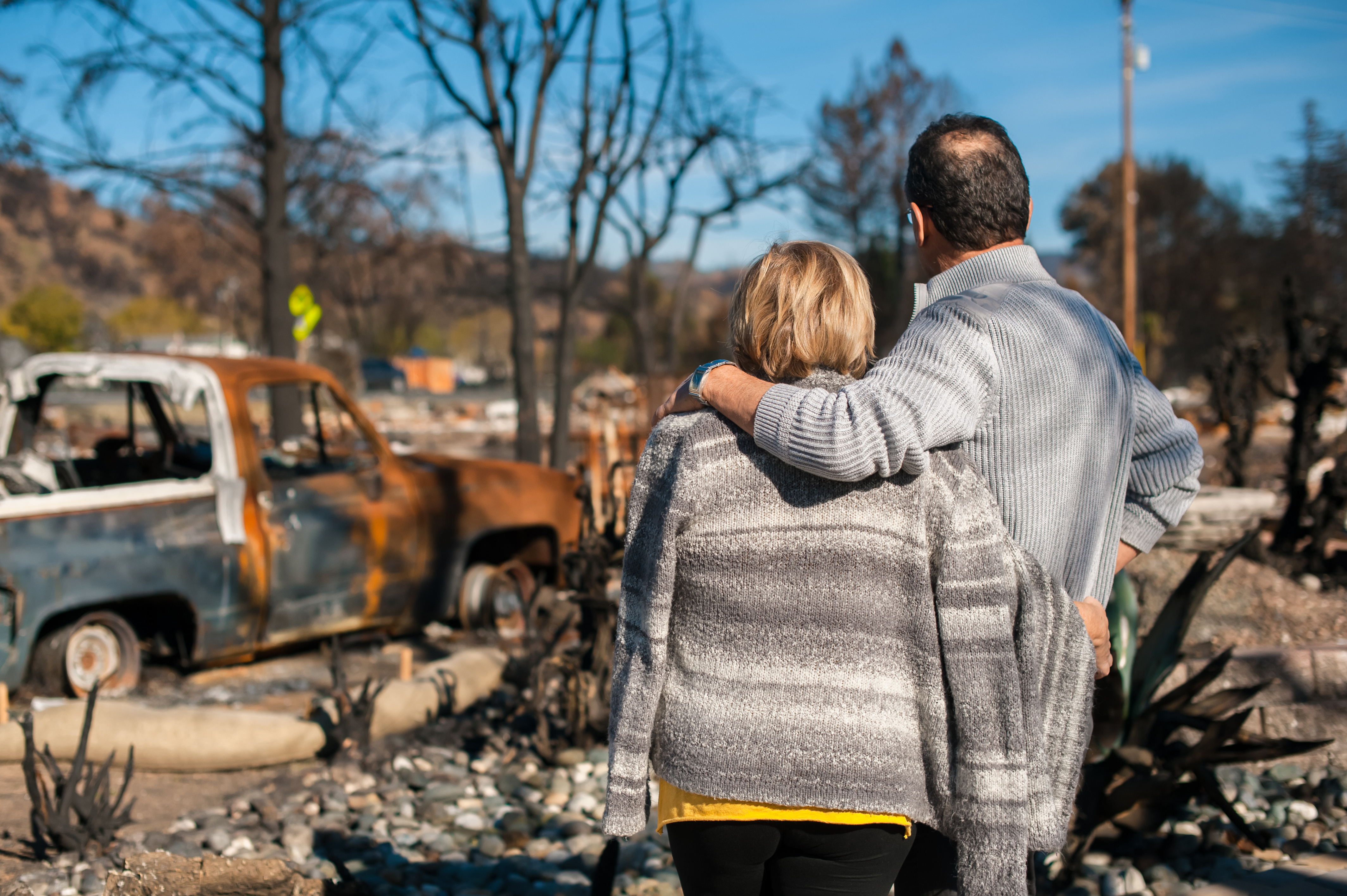 Two adults looking at a place after disaster