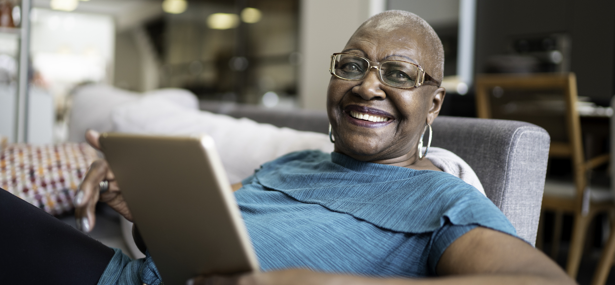 a woman smiling and holding laptop