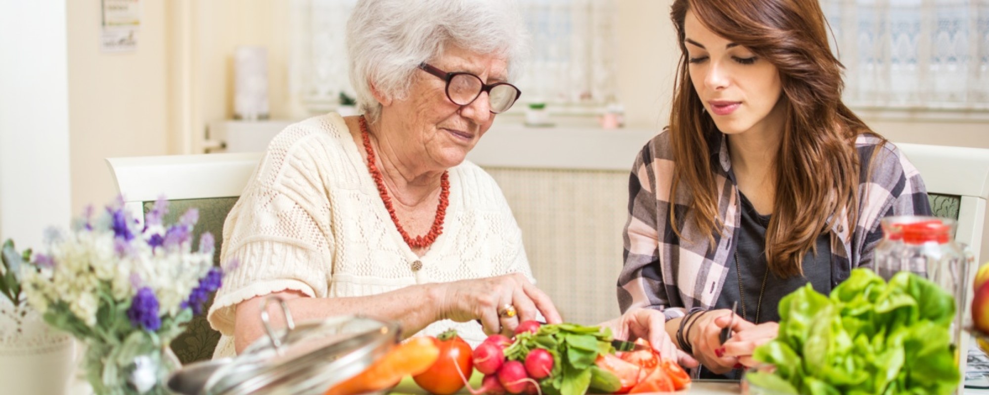 A grandmother and her granddaughter cooking dinner