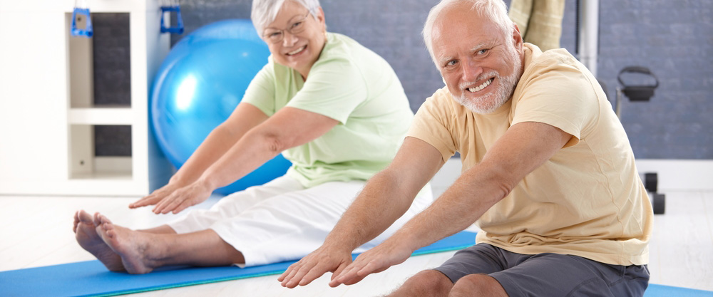 Two elderly people exercising