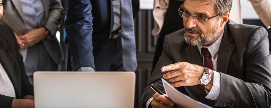 An elderly man working in an office