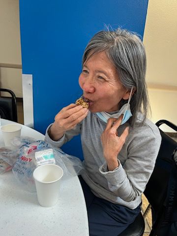 Image of a person sitting in chair and eating