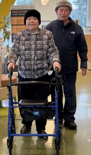 Mr. Doan and MRs.Tang smiling and standing