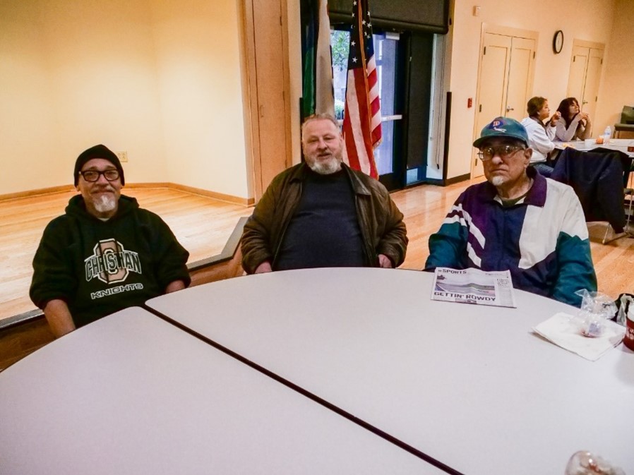 A group of men sitting at a table