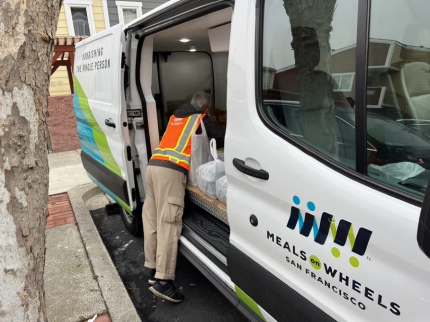 A person getting into Meals on Wheels vehicle of San Francisco