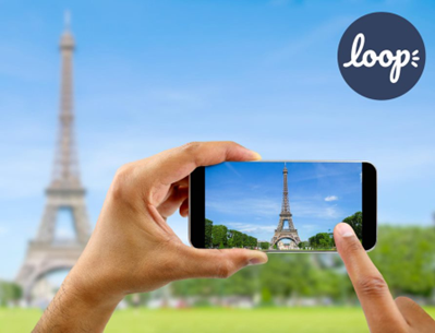 Tourist in Paris visiting landmark Eiffel tower, sightseeing in France, man taking photo on mobile phone